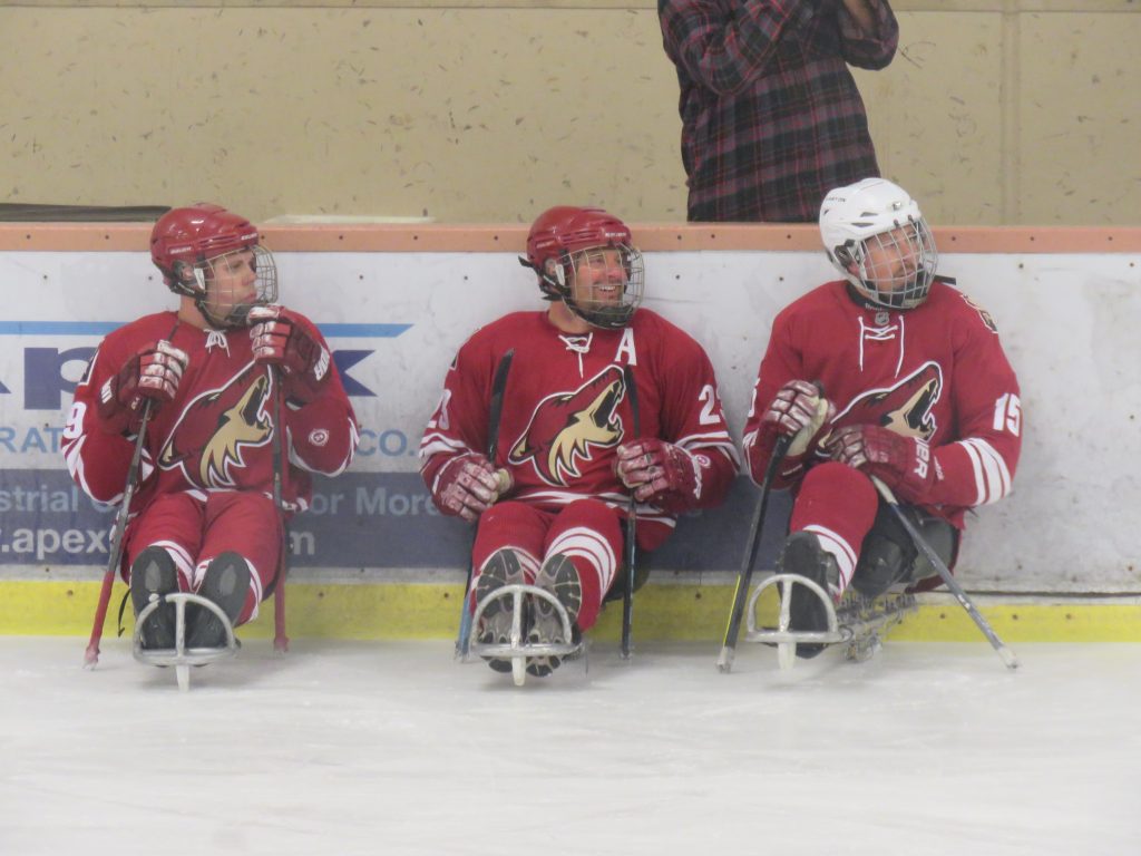 The Coyotes Sled Hockey defensive players waiting to rotate into the game.